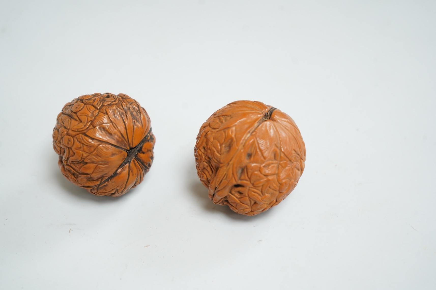 Two Chinese carved walnuts, approximately 4cm in diameter
